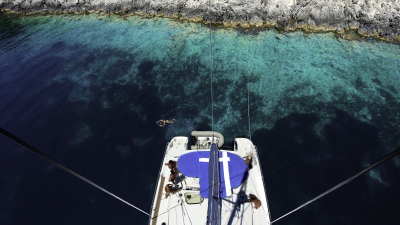 Catamaran sailing near secluded bay in Greece