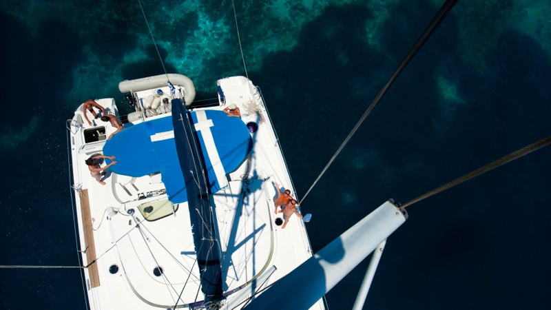 Catamaran sailing near secluded bay in Greek sea